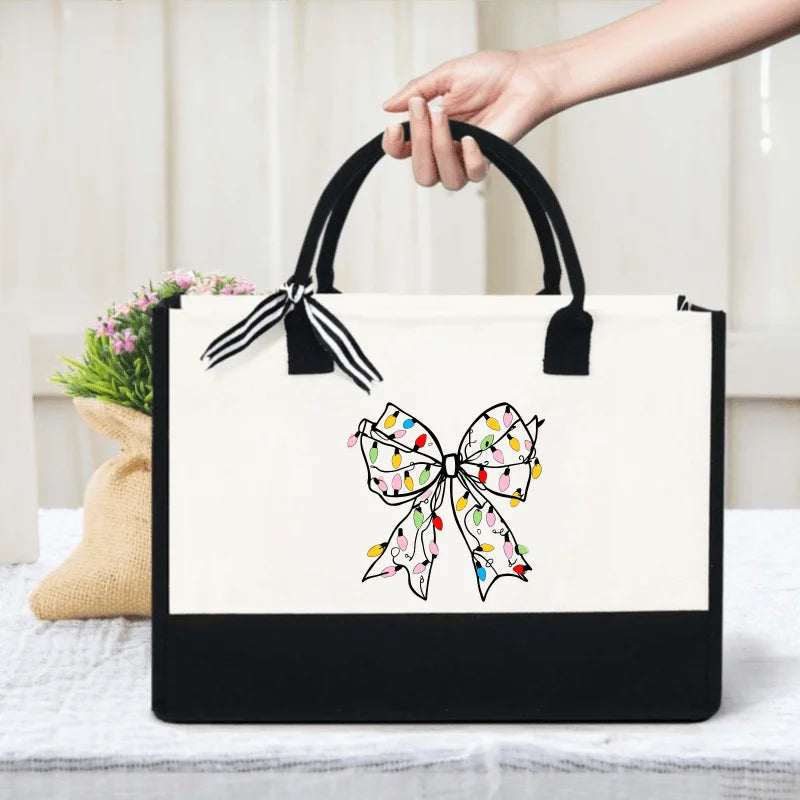 White canvas handbag with colorful bow print, suitable for daily use
