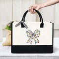 White canvas handbag with colorful bow print, suitable for daily use