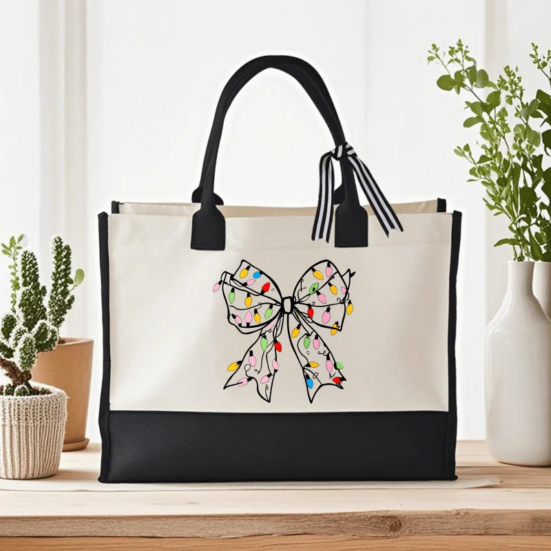 White canvas handbag with colorful bow print, suitable for daily use